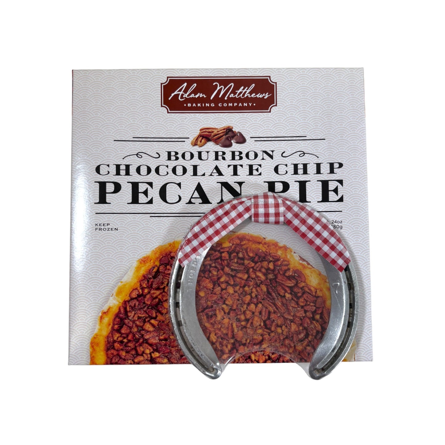 Packaged bourbon chocolate chip pecan pie with a horseshoe and checkered ribbon on a white background