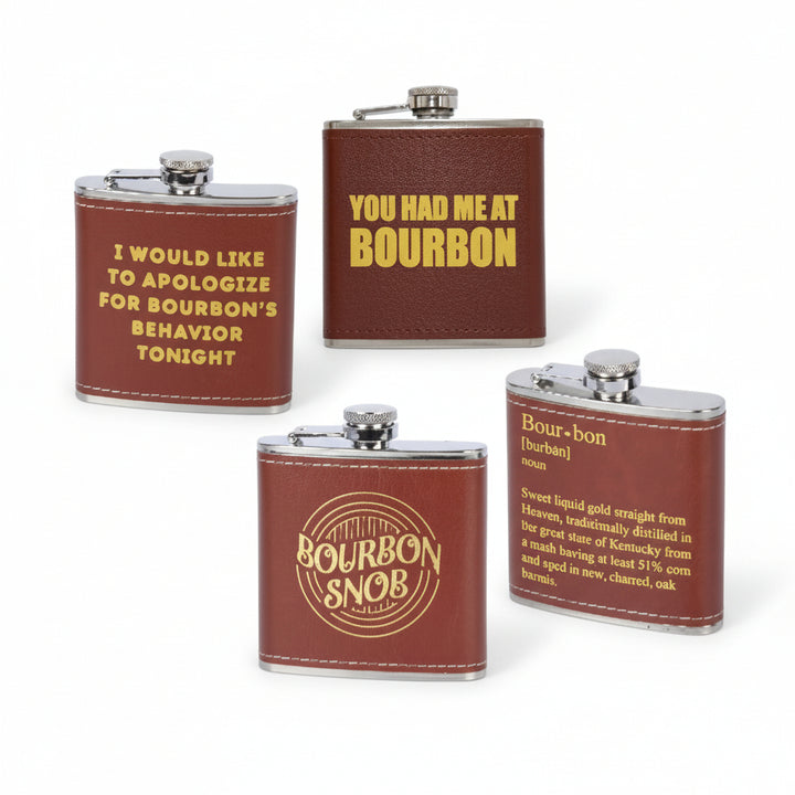 A group display of four black faux leather flasks with gold lettering, featuring different humorous bourbon quotes.