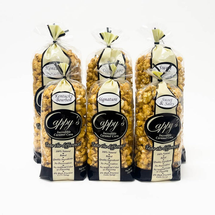 Three packages of Aappy's caramel corn with visible branding on a white background