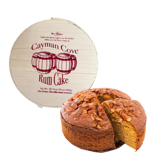 The Cayman Cove Rum Cake 8" packaged in its signature round, wood-lidded gift box, ready for gifting.