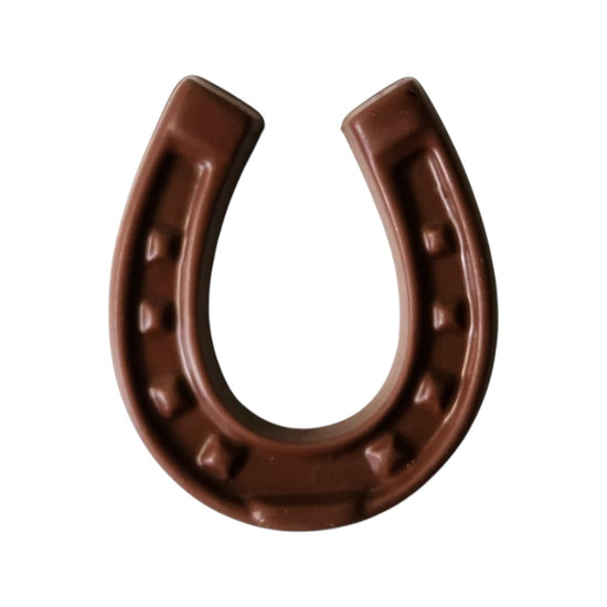 Brown dark chocolate horseshoe on a white background