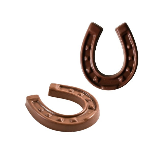 Two chocolate horseshoes on a white background