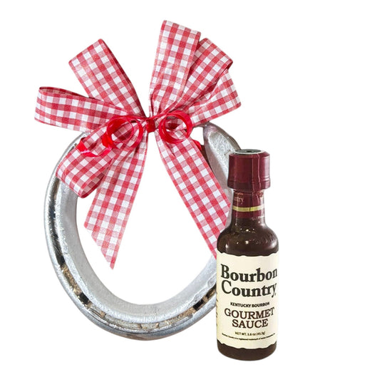 Genuine track horseshoe Derby gift paired with a mini bottle of Kentucky Bourbon Country Gourmet Sauce, finished with a handmade gingham bow.