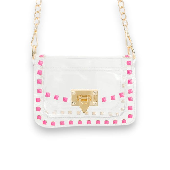 The Jackie clear crossbody bag with bright pink trim and a gold chain strap against a white background.