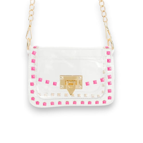 The Jackie clear crossbody bag with bright pink trim and a gold chain strap against a white background.