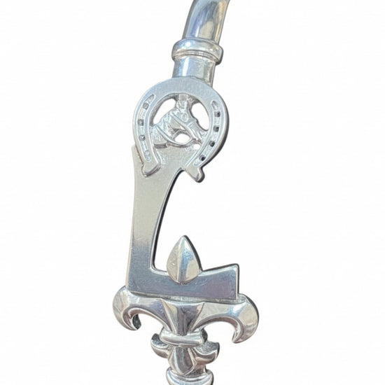 Silver bracelet with decorative clasp on a white background