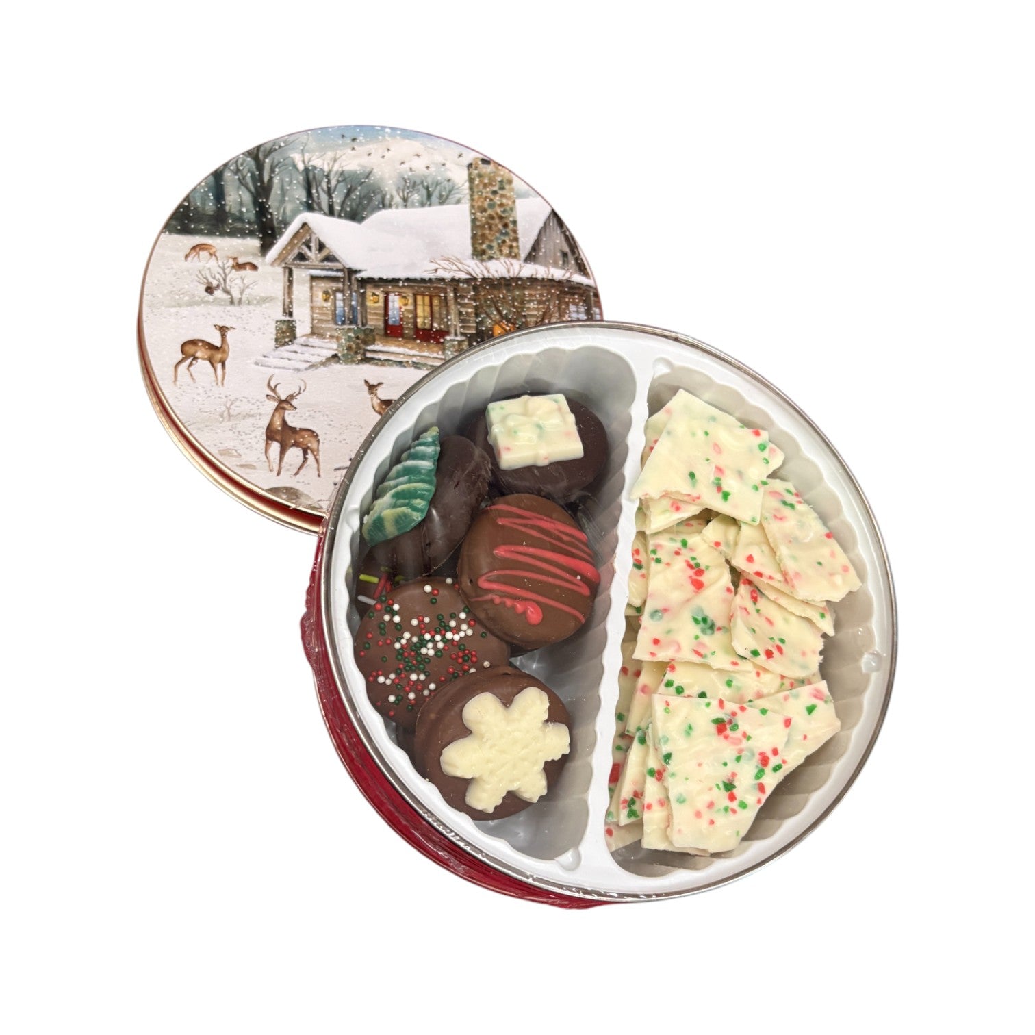 A close-up view of the assorted Christmas bark and cookies in the small tin.