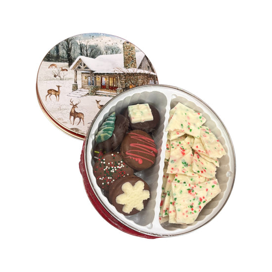 A close-up view of the assorted Christmas bark and cookies in the small tin.