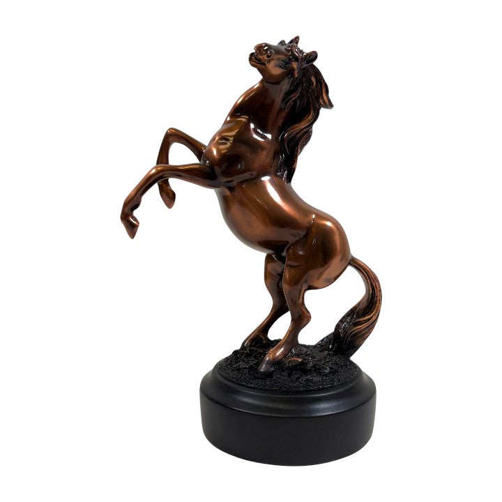 Copper statue of a rearing horse on a white background