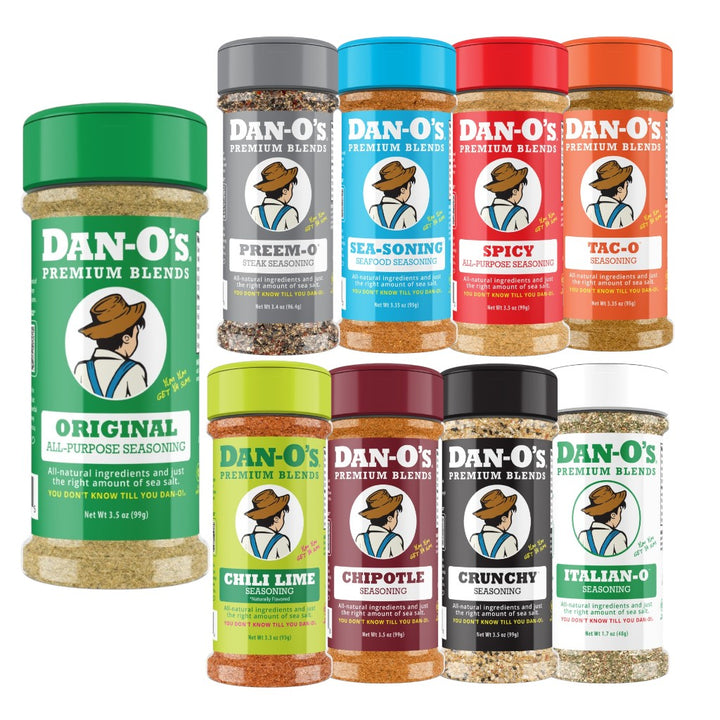 A group shot of nine small bottles of Dan-O's Premium Seasoning Blends, including Original, Taco, and Spicy.