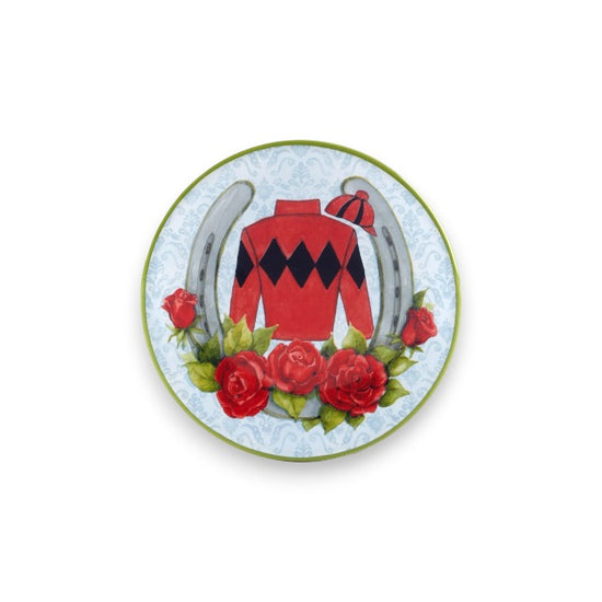 Decorative plate with a red jockey's shirt, horseshoes, and roses on a white background