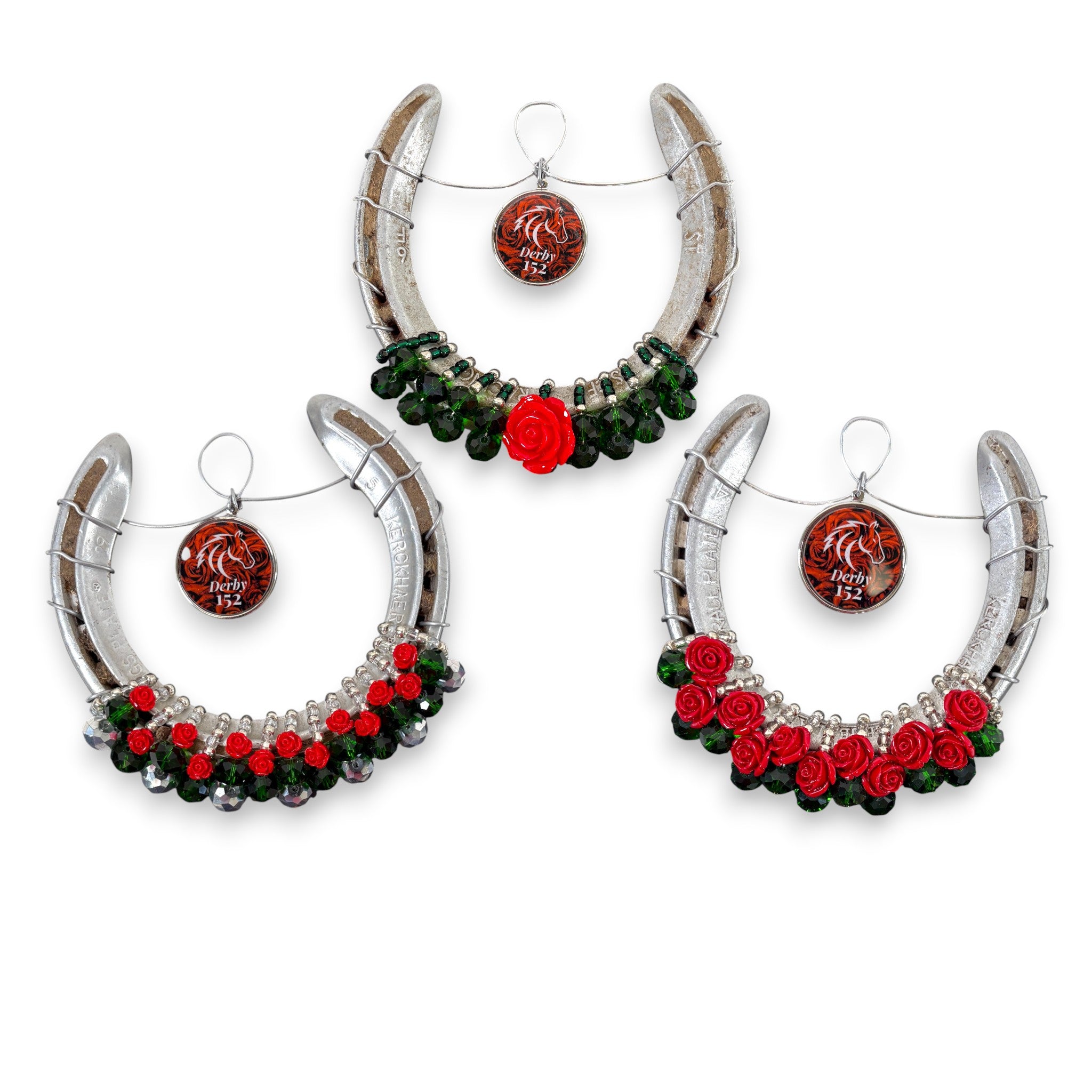 An authentic Churchill Downs horseshoe decorated with a lush garland of red roses and a commemorative "152" charm.