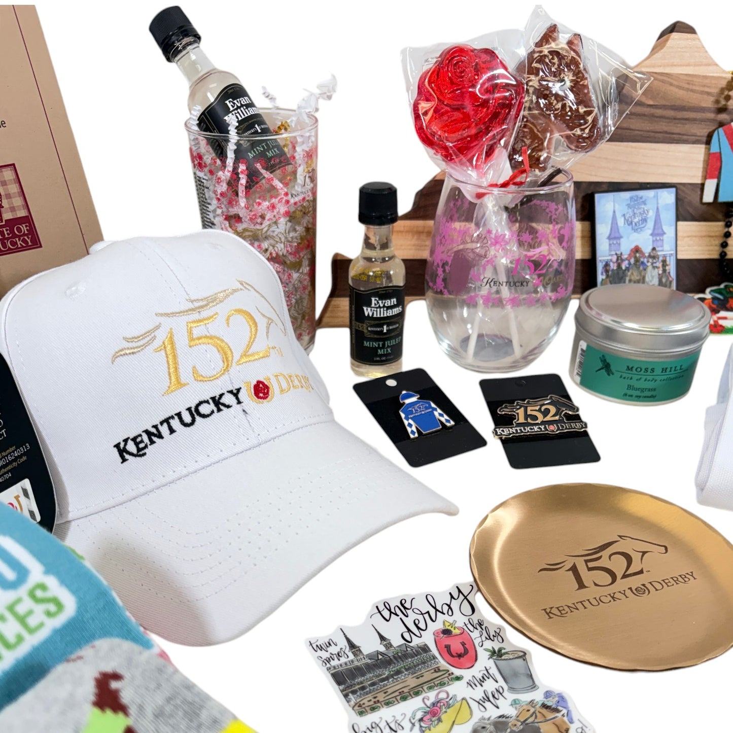 Detail shot of Derby 152 merchandise: baseball cap, cutting board, socks, and commemorative glassware.