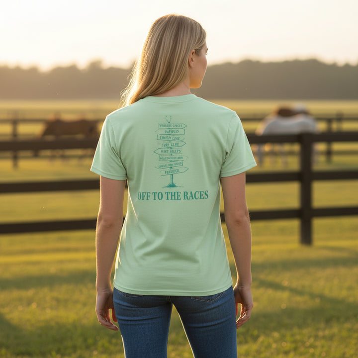 A model wearing the unisex spearmint green Kentucky Derby 152 signpost t-shirt in a casual, outdoor setting.