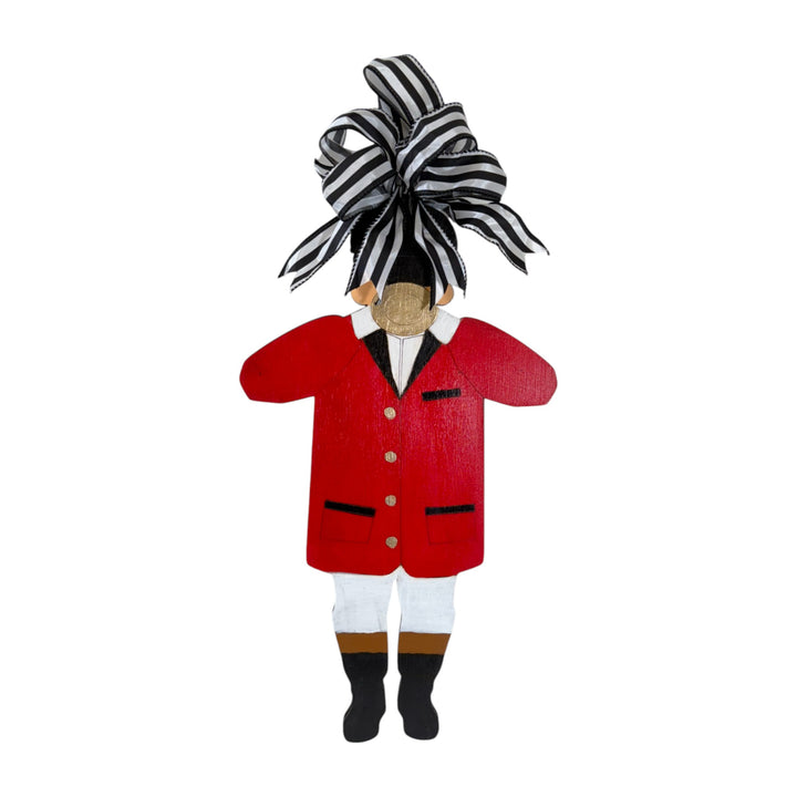 Decorative figure of a character in a red coat with a large black and white bow on a white background