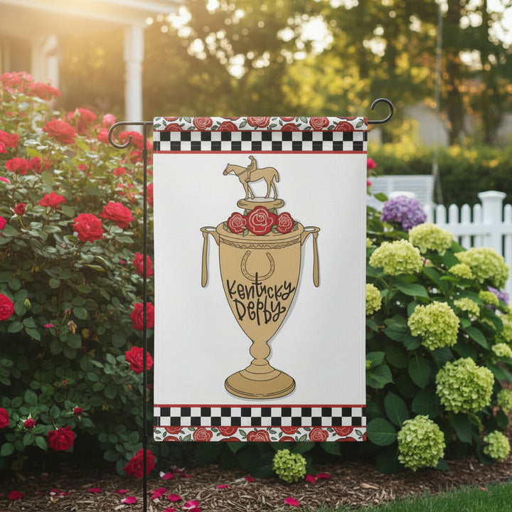 The 12" x 18" double-sided garden flag displayed outdoors amongst red roses, celebrating the Kentucky Derby.