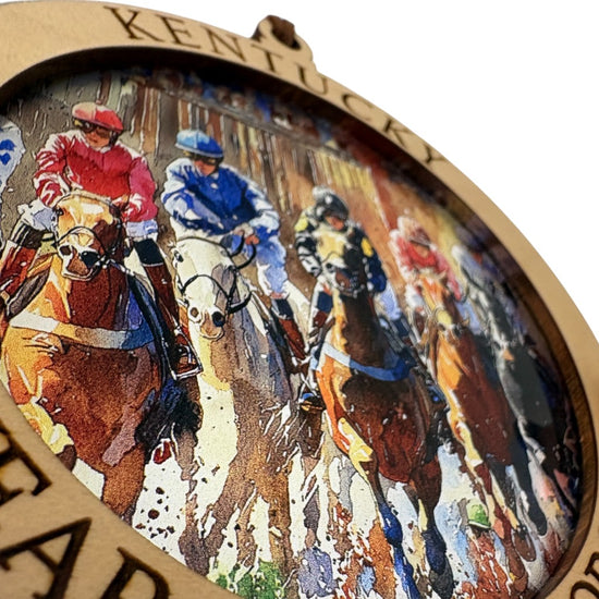 A close-up detail shot of the "Kentucky Year of the Horse 2026" engraving on the wooden snow globe frame.