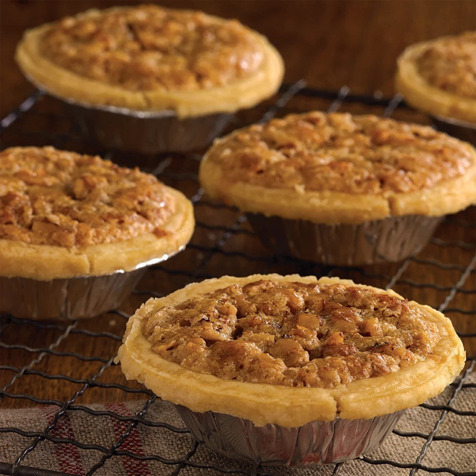 Small pies on a cooling rack with a wooden background