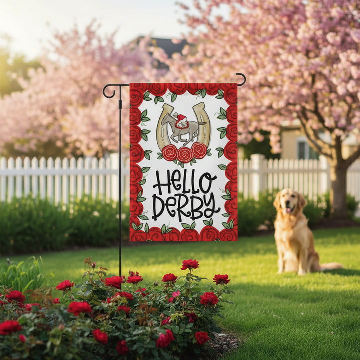 Garden flag with 'Hello Derby' text and horse design, dog sitting in a garden with flowers and trees.