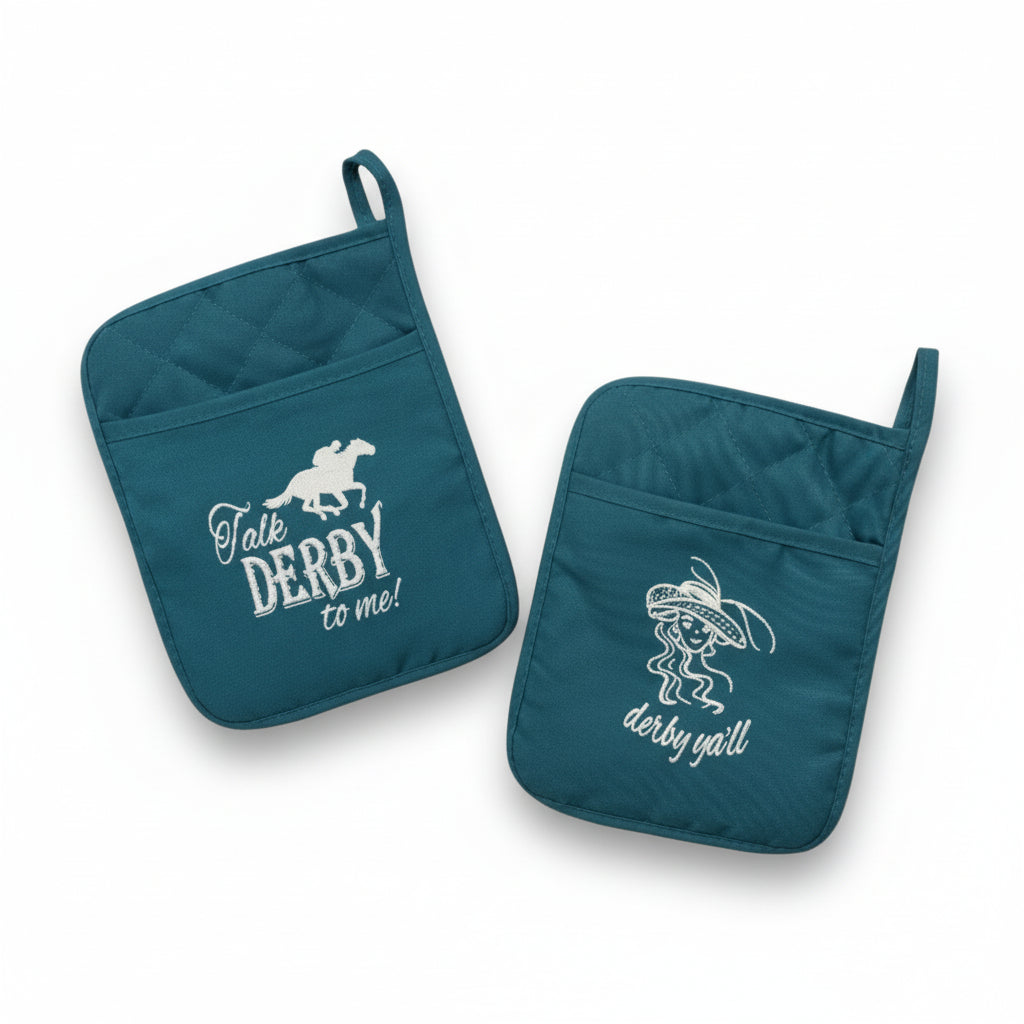 Two teal pot holders displayed together, one featuring a "Talk Derby to Me" design with a jockey and the other a "Derby Y'all" design with a lady in a hat.