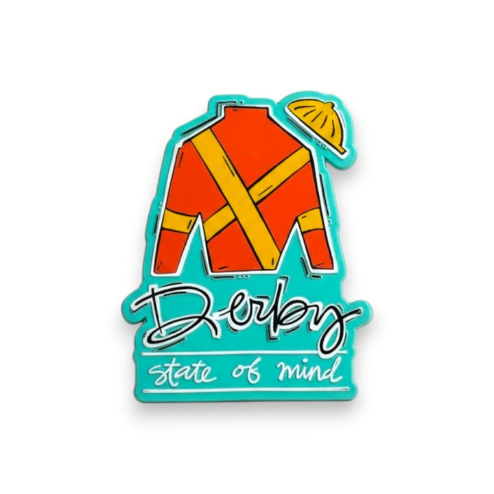 A 3x2 inch magnet shaped like jockey silks and a banner, featuring an orange and yellow jockey uniform and the text 'Derby state of mind' on a turquoise background.