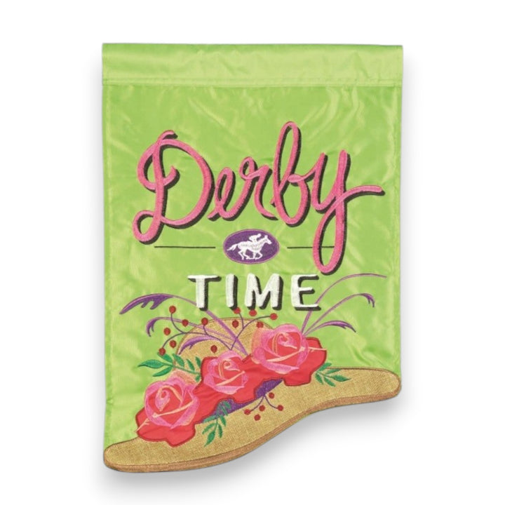 A lime green garden flag featuring pink embroidered Derby Time text and a gold wide-brimmed hat decorated with three red roses and green leaves.