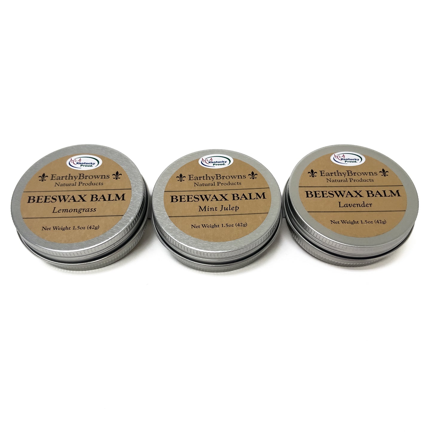 Three tins of Beeswax Balm with different scents on a white background