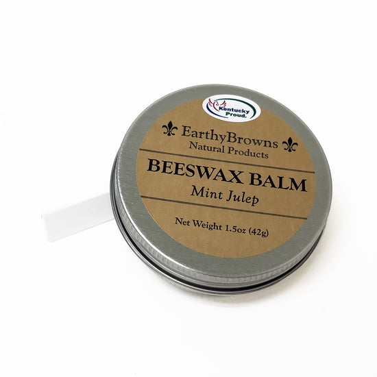 Beeswax balm tin with 'Earthy Browns' label on a white background