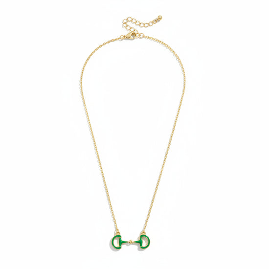 A close-up detail shot of the green Eclipse Enamel Horsebit Necklace pendant on its gold-tone chain.
