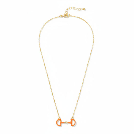 A close-up detail shot of the Orange Eclipse Enamel Horsebit Necklace pendant on its gold-tone chain.