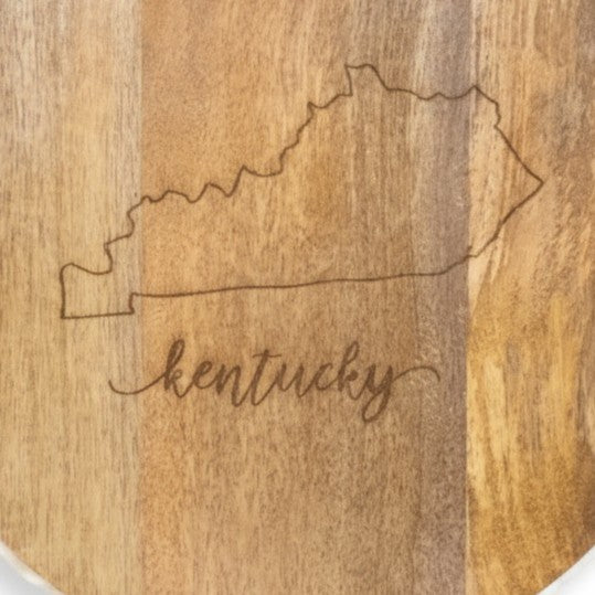 Detail shot of the laser-engraved Kentucky state outline and script on the wood board.