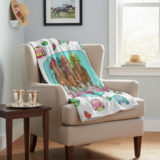 Vibrant Derby Day horse racing fleece blanket draped comfortably over a living room armchair.