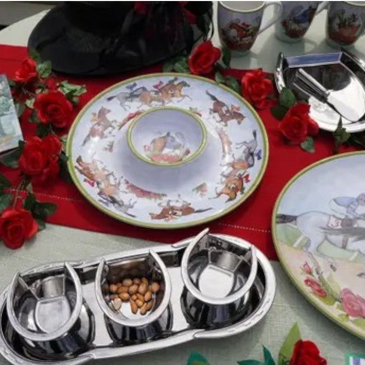 A lifestyle shot of the "Day at the Races" chip and dip platter filled with snacks and served at a festive Derby-themed party.