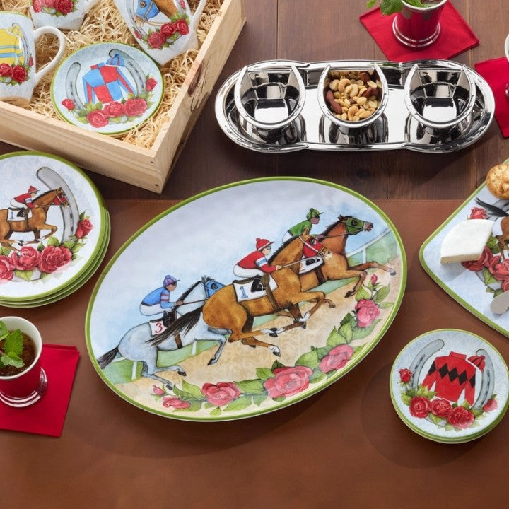 A lifestyle photo of the "Day at the Races" oval platter laden with hors d'oeuvres, serving as the centerpiece on a beautifully set table for a Kentucky Derby party.