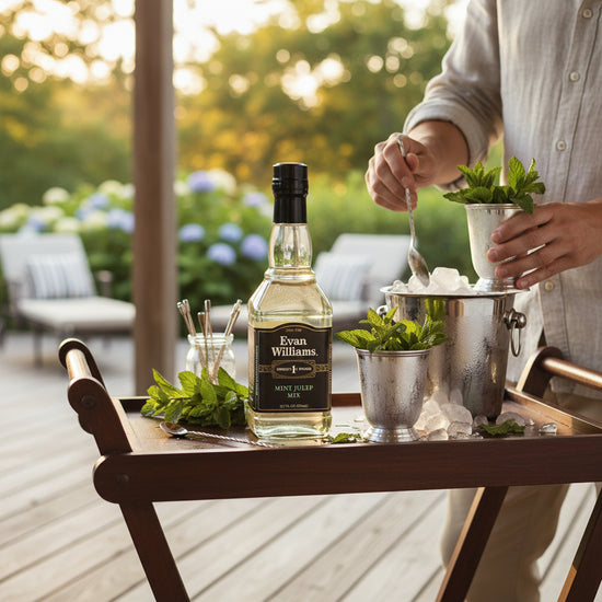 Bottle of Evan Williams Mint Julep on a bar cart with mint leaves and ice, outdoor setting.