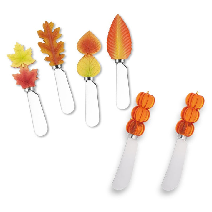 Set of four leaf-shaped cheese knives on a white background