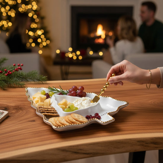 A cozy holiday table featuring the tree-shaped serving dish filled with festive snacks.