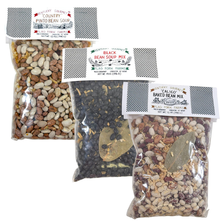 A group shot of the three Flag Fork Farms bean mix packages: Black Bean, Country Pinto Bean, and Calico Baked Bean.