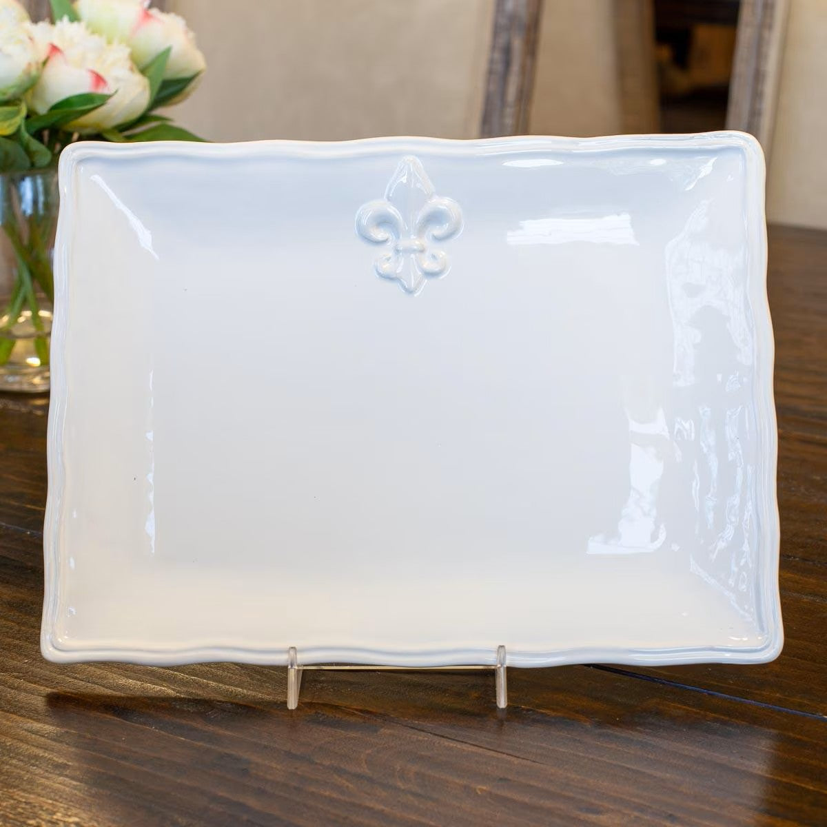 A stunning small 11.5 by 8.5 inch white dolomite serving platter displaying a classic Fleur de Lis motif.