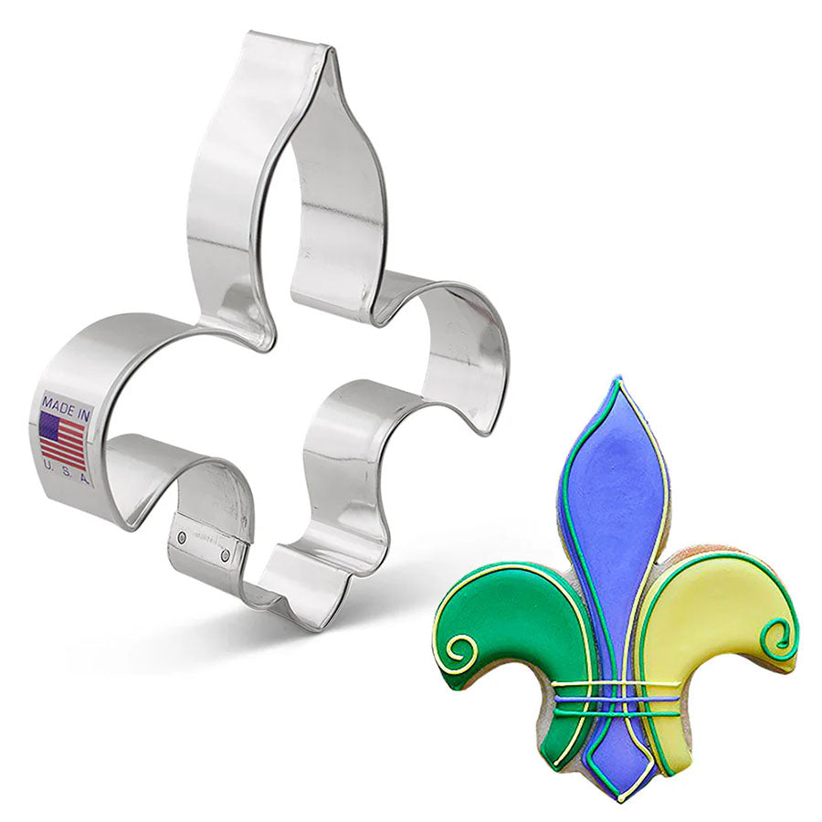Metallic cookie cutter shaped like a colorful fleur-de-lis with a plain white background