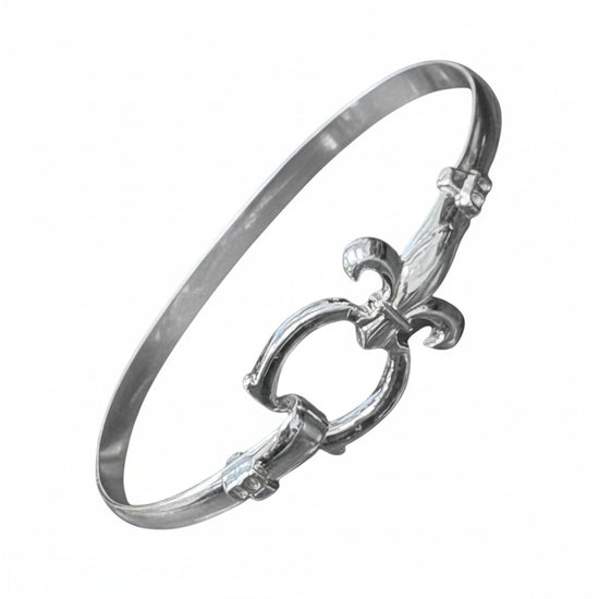 The elegant sterling silver bracelet featuring a detailed fleur-de-lis design.
