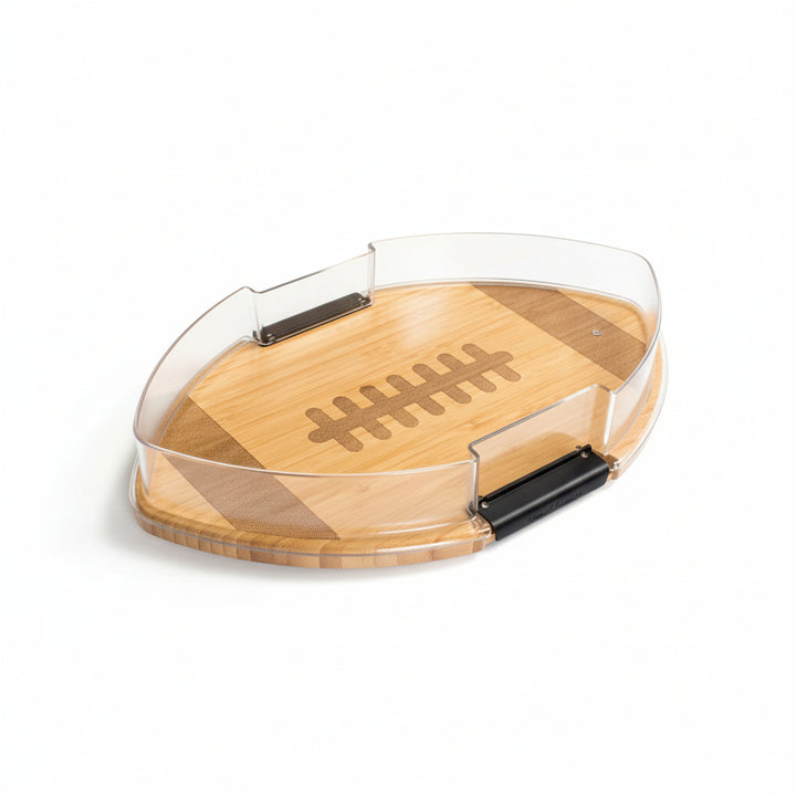  A bamboo football-shaped charcuterie board, featuring a clear locking lid for secure transport.