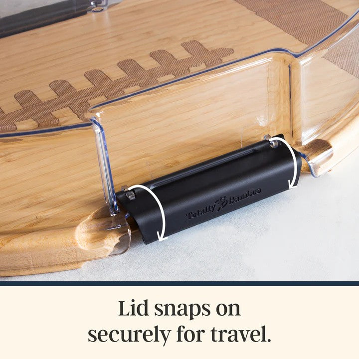 Close-up detail of the clear locking lid on the football charcuterie board, for secure transport.