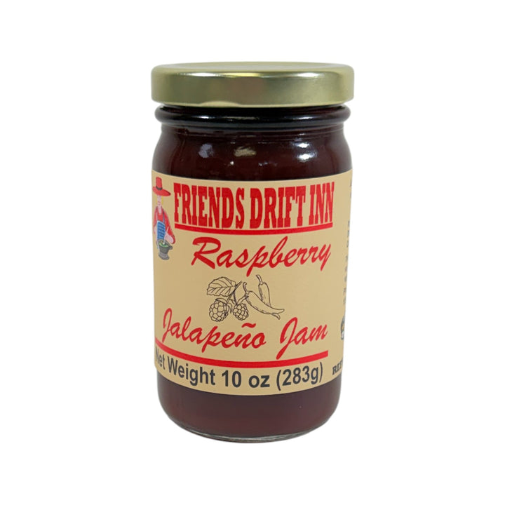 A glass jar of Friends Drift Inn Raspberry Jalapeno Jam, showing its deep red color.