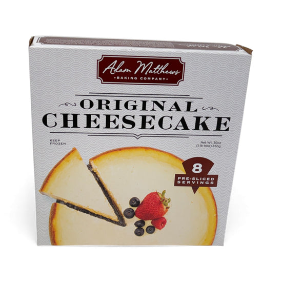 Box of Adam Matthews Baking Company Original Cheesecake with a slice of cheesecake and berries on the packaging.