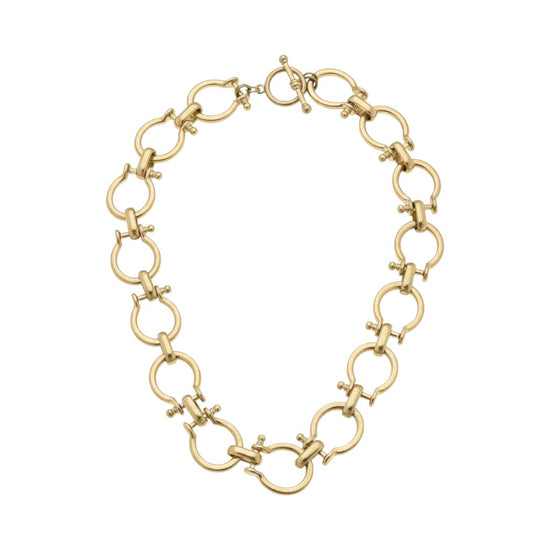 The shiny gold Horsebit Linked Necklace laid out in a circle on a white background.