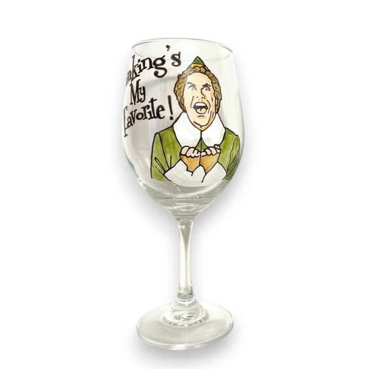 A stemmed wine glass featuring a hand-painted design of Buddy the Elf.