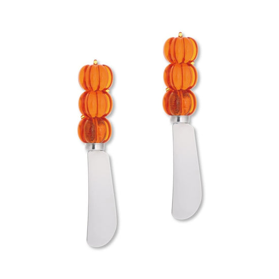 Two cheese knives with orange pumpkin-shaped handles on a white background