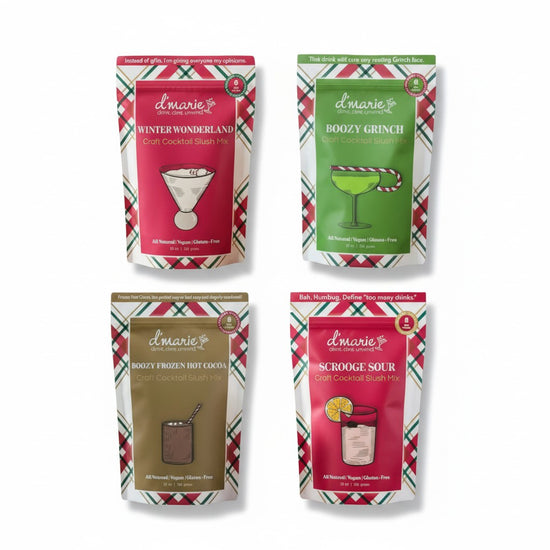 Four packages of d'marie holiday-themed cocktail mix on a white background