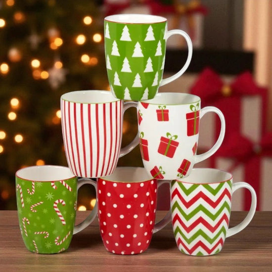 Set of Christmas-themed mugs with patterns on a wooden surface.